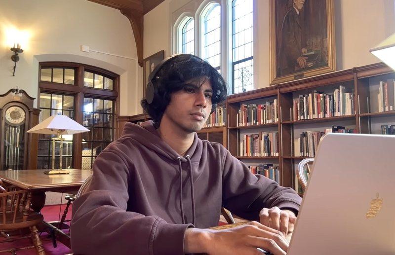 Samarth working on a laptop in a library